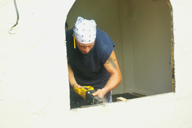 Window installation by worker with power tool